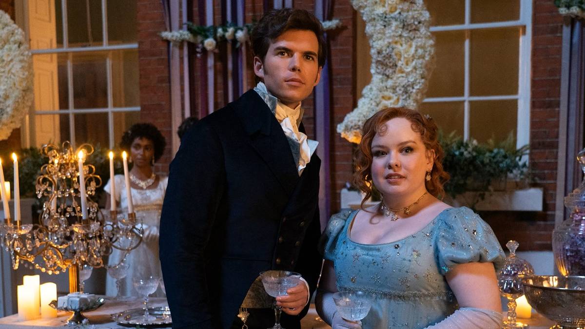 Colin (Luke Newton) & Penelope (Nicola Coughlan) standing together at a ball in 'Bridgerton' Season 3.