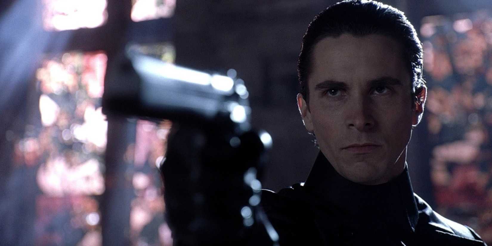 Christian Bale as John Preston pointing a gun at a target offscreen in Equilibrium