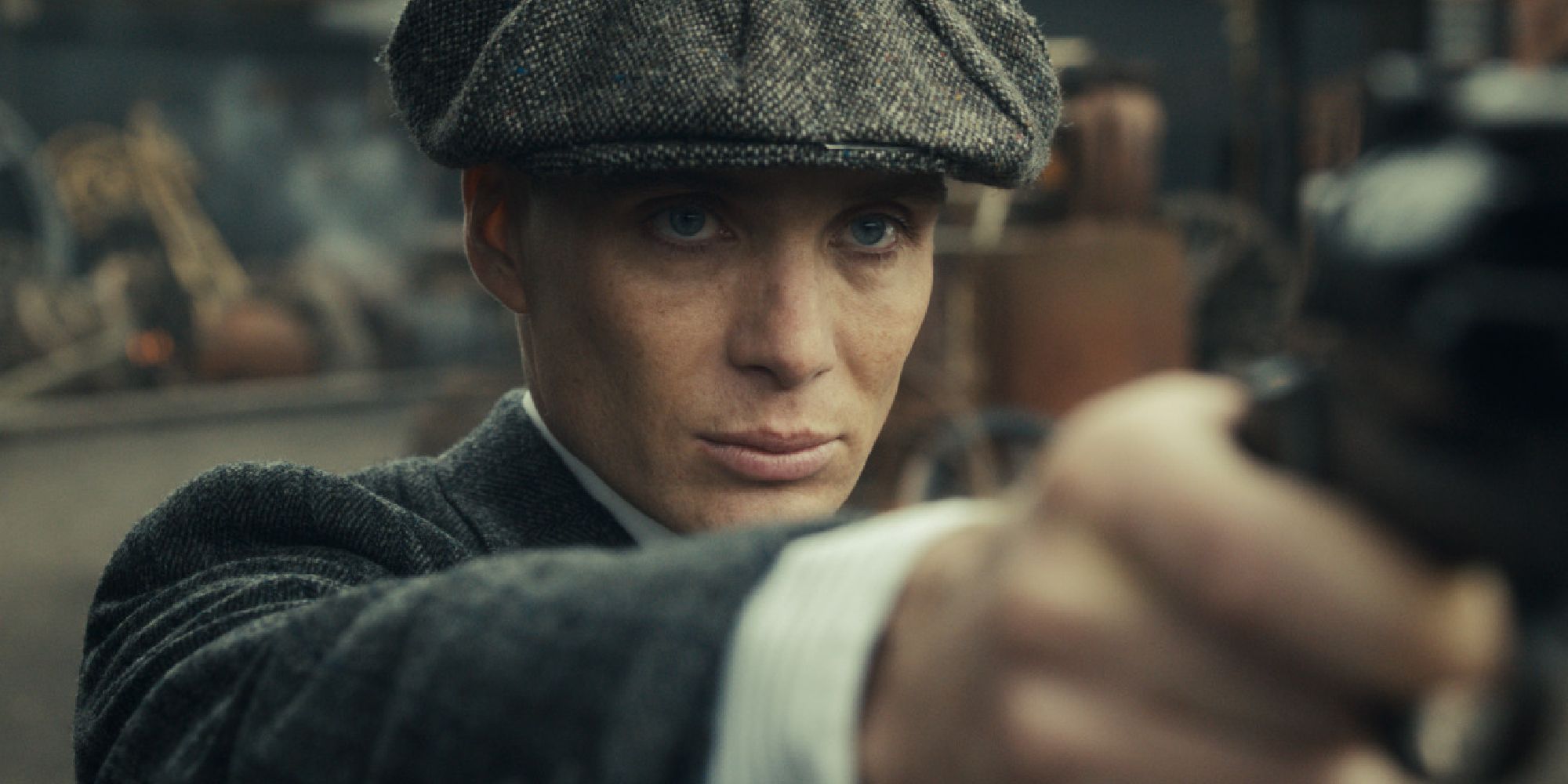 Cillian Murphy pointing a gun in Peaky Blinders
