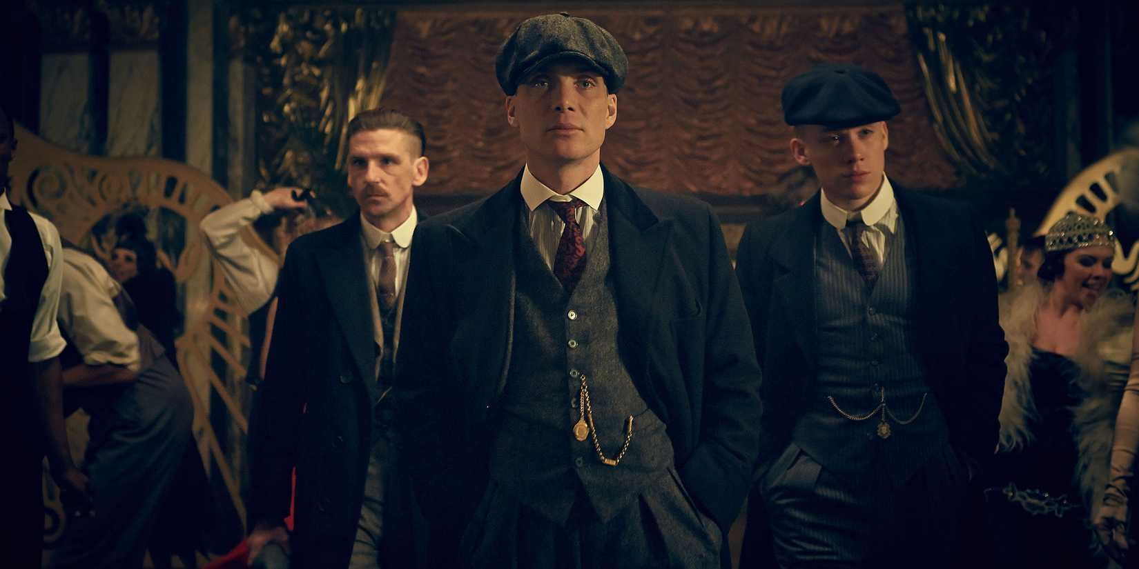 Cillian Murphy, Paul Anderson, and Joe Cole as Thomas, Arthur, and John Shelby, walking into a club in Peaky Blinders
