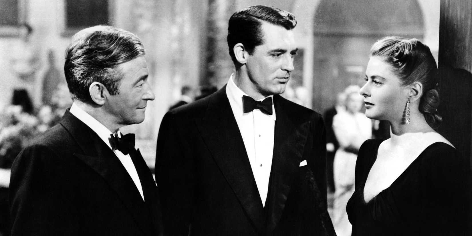 Claude Rains, Cary Grant, and Ingrid Bergman conversing at a black tie party in 'Notorious' 