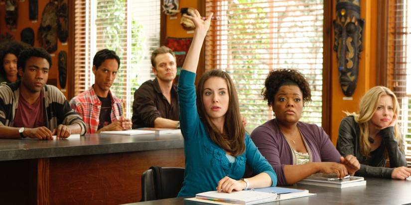 Annie (Alison Brie) raising her hand in a classroom in Community.