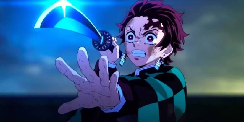 Tanjiro with his black nichirin blade in Demon Slayer: Mugen Train.