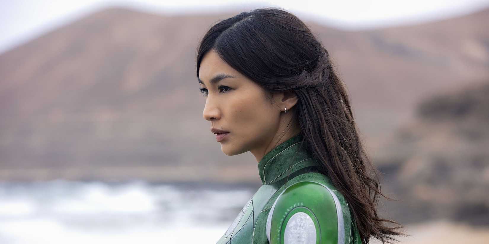 Close up of Gemma Chan as Sersi looking to the distance on a beach in Eternals.