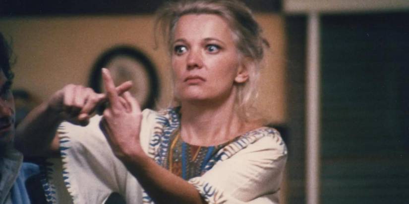 Gena Rowlands as Mabel Longhetti doing the cross sign with her fingers in the film A Woman Under the Influence 1