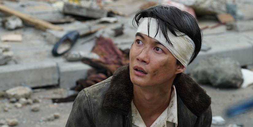 Kochi Shikishima with a bandage on his head looks up amid rubble in Godzilla Minus One