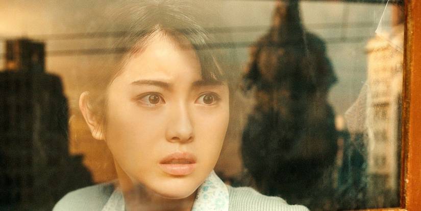 Minami Hamabe as Noriko Oishi staring out a window at Godzilla in Godzilla Minus One
