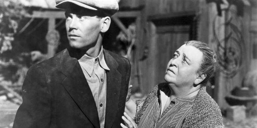 Tom Joad looking to the distance while Ma looks at him concerned in The Grapes of Wrath