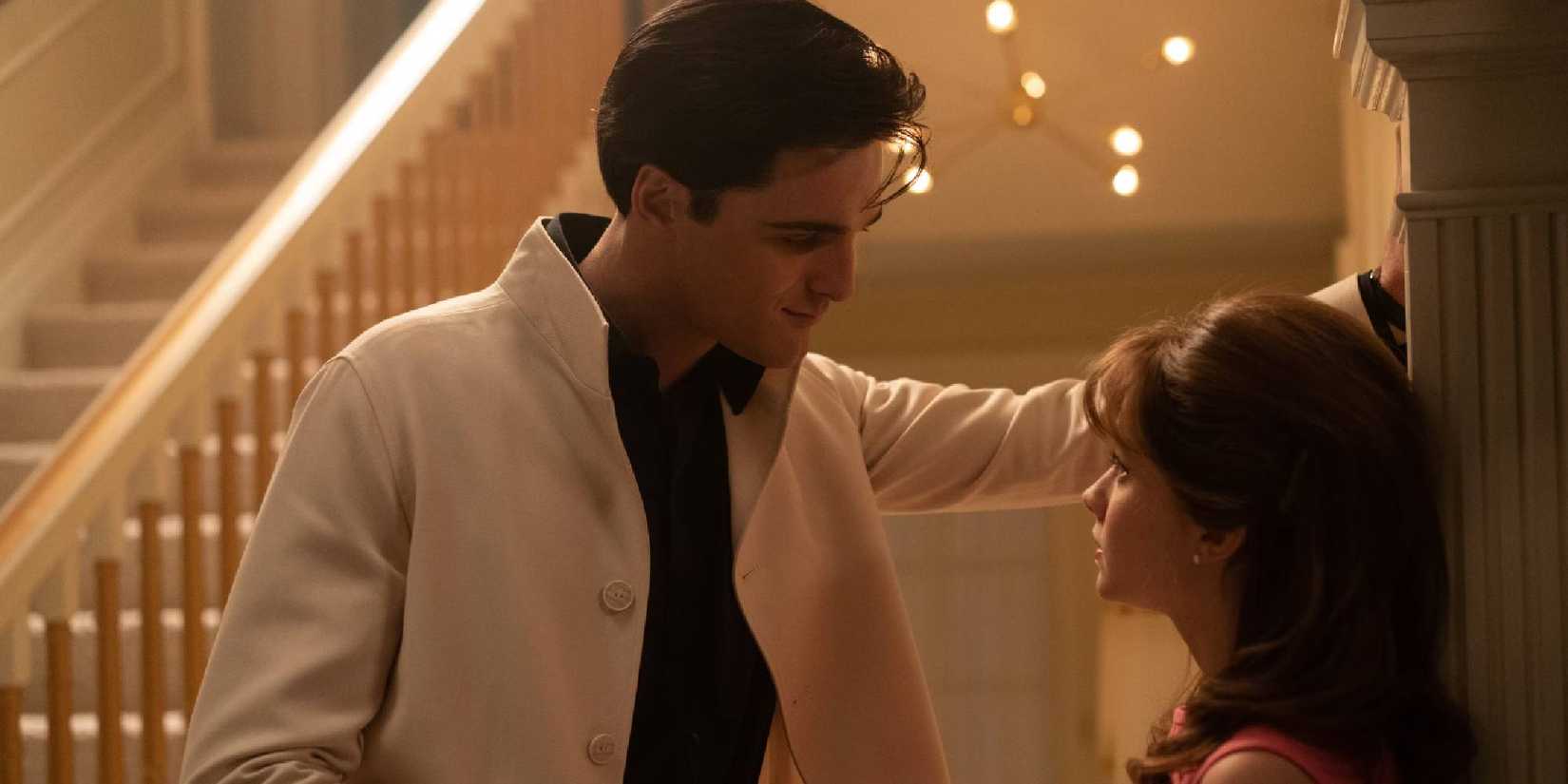 Jacob Elordi as Elvis Presley looking at Cailee Spaeny as Priscilla Presley and smiling in Priscilla.