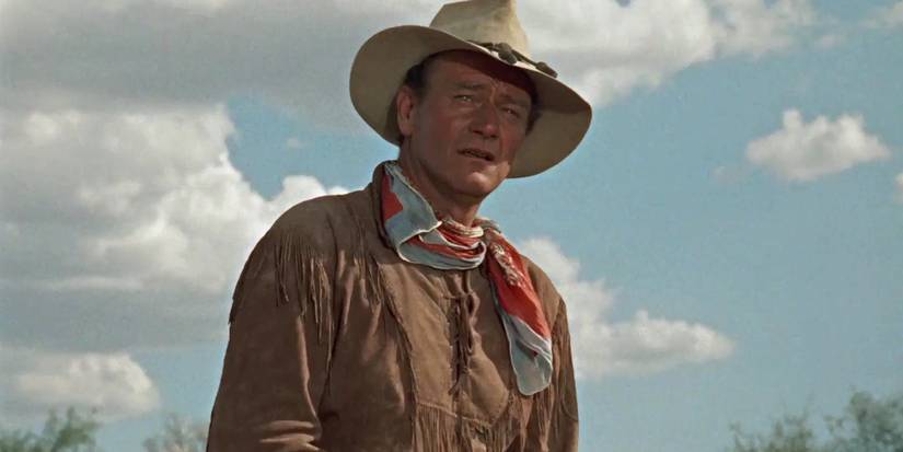 John Wayne as Hondo wearing a cowboy hat and colorful neck scarf in Hondo
