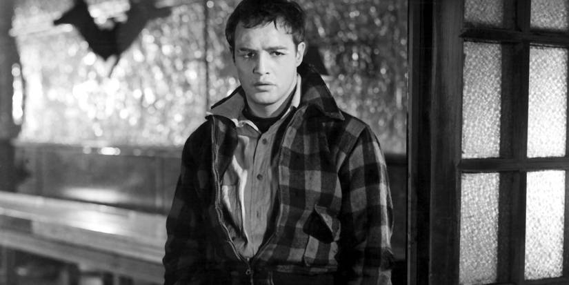 Marlon Brando as Terry standing and looking pensive in On the Waterfront