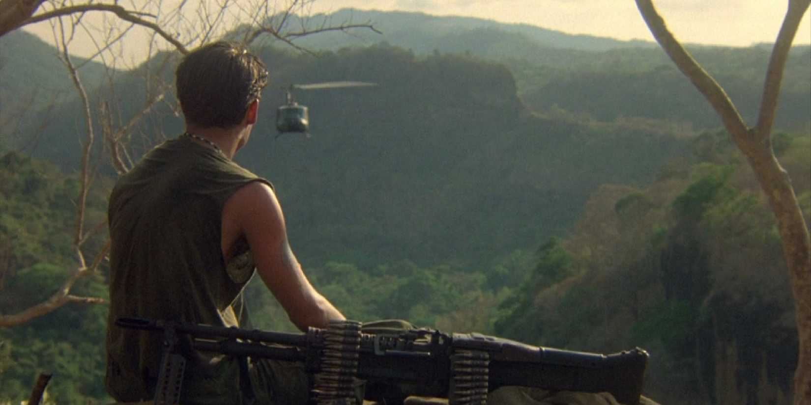 A soldier looks at the forest and an oncoming helicopter in Oliver Stone's Platoon