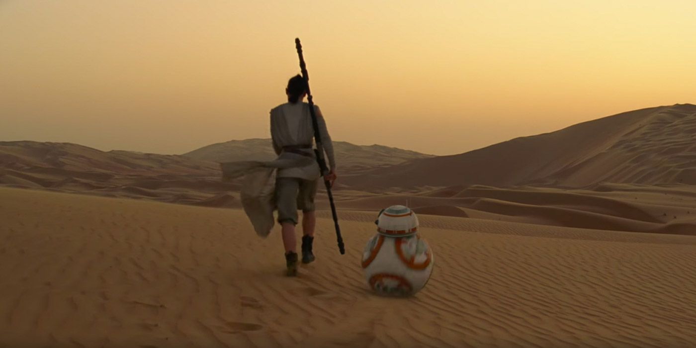 Rey and BB-8 in walking into the desert in Star Wars: The Force Awakens