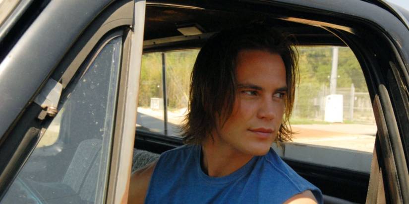 Taylor Kitsch as Tim Riggins driving in truck in Friday Night Lights