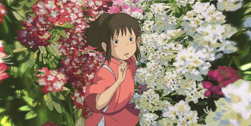 Chihiro standing among flowers and looking up in 'Spirited Away'.