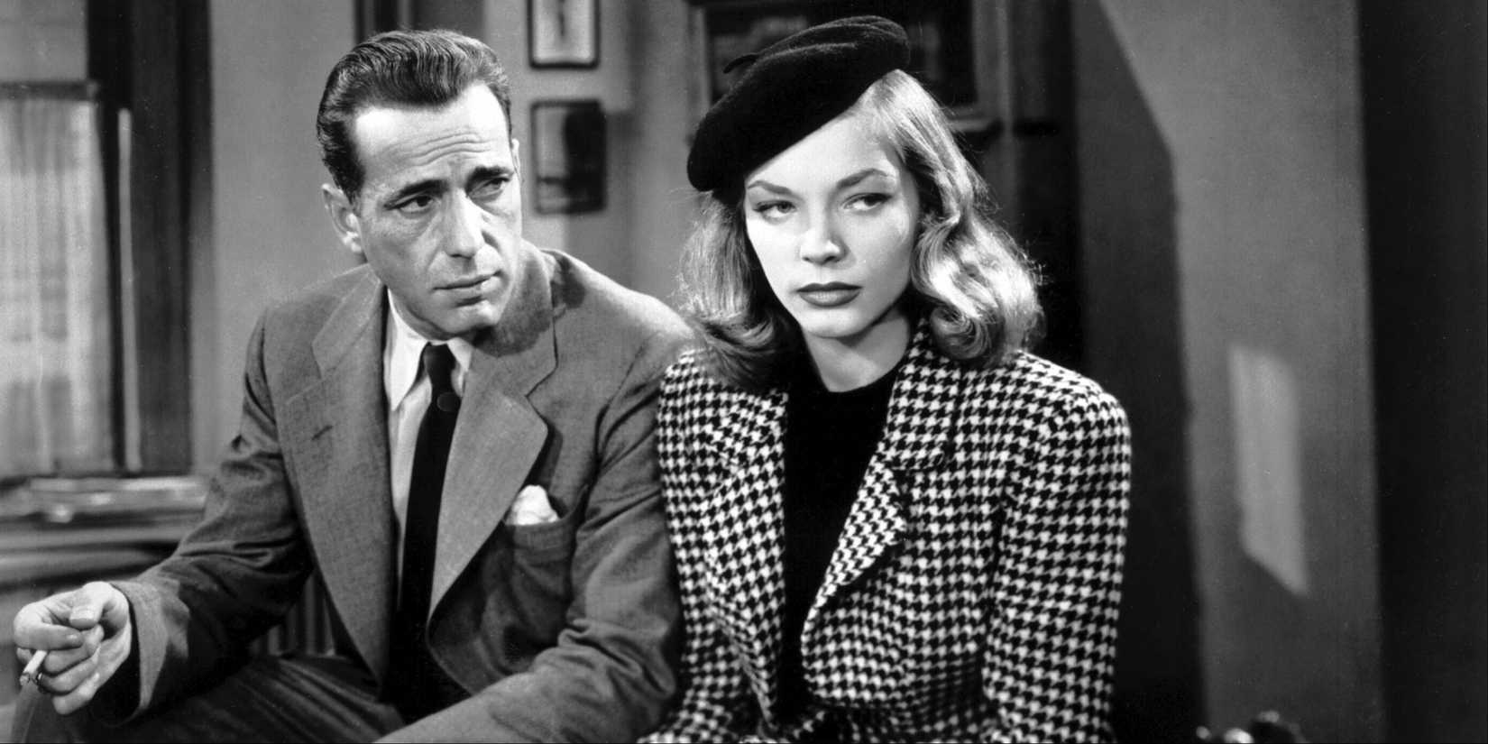 Humphrey Bogart and Lauren Bacall sitting and talking in The Big Sleep