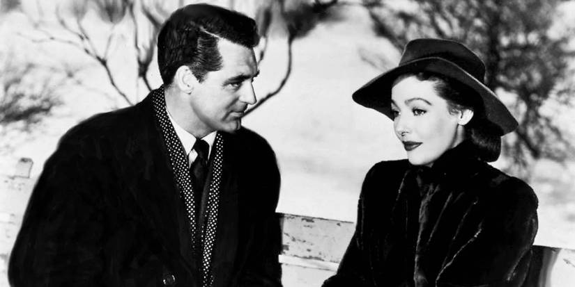Cary Grant's Dudley sits next to and looks at Loretta Young's Julia on a park bench in The Bishop's Wife.