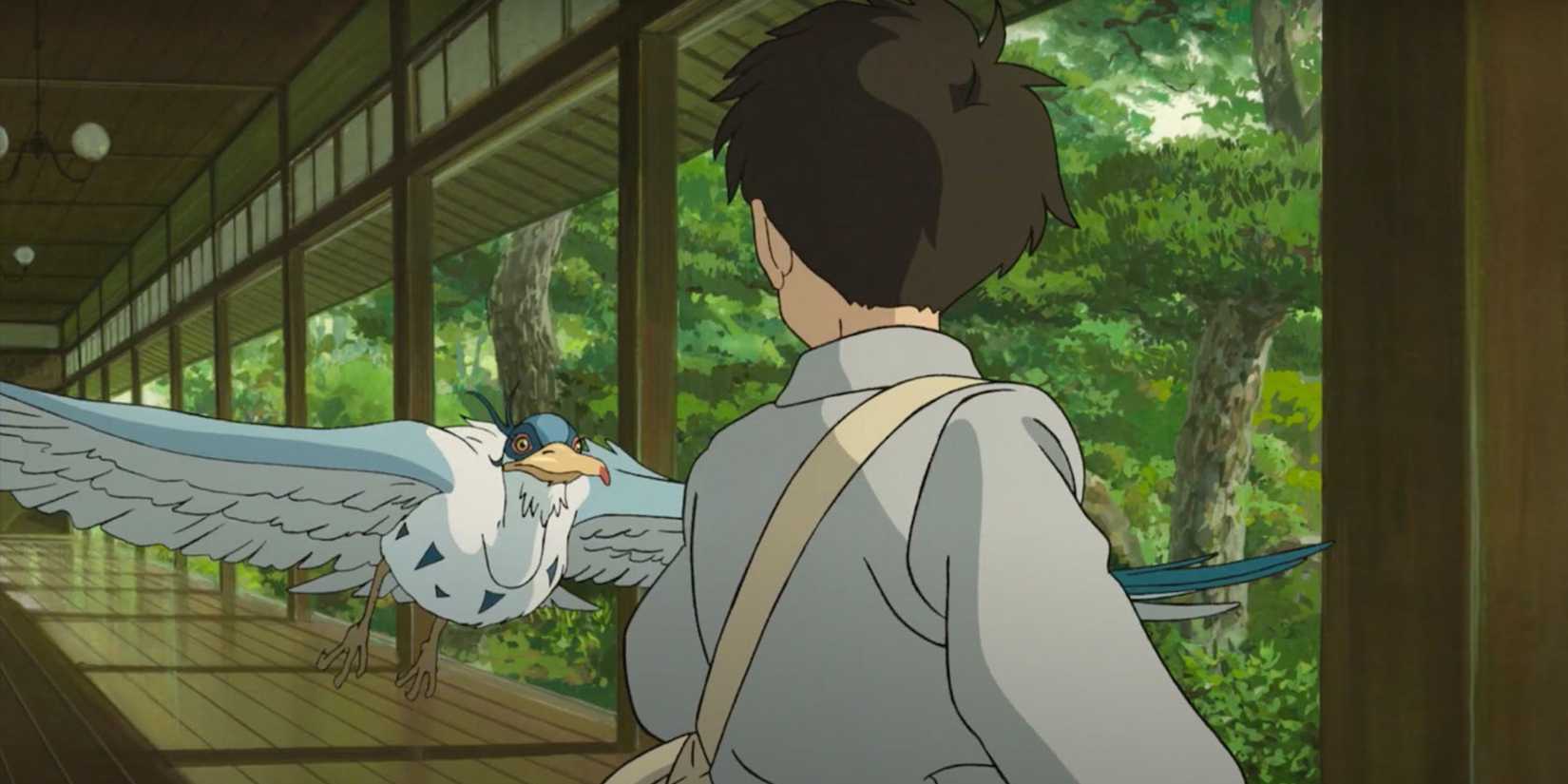 Mahito looking at a large, Grey Heron as it flies toward him in The Boy and the Heron, 2023.