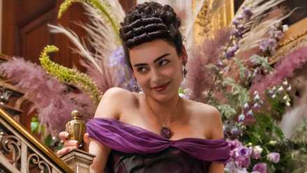 Aubri Ibrag wearing a purple dress and smiling in The Buccaneers Episode 4