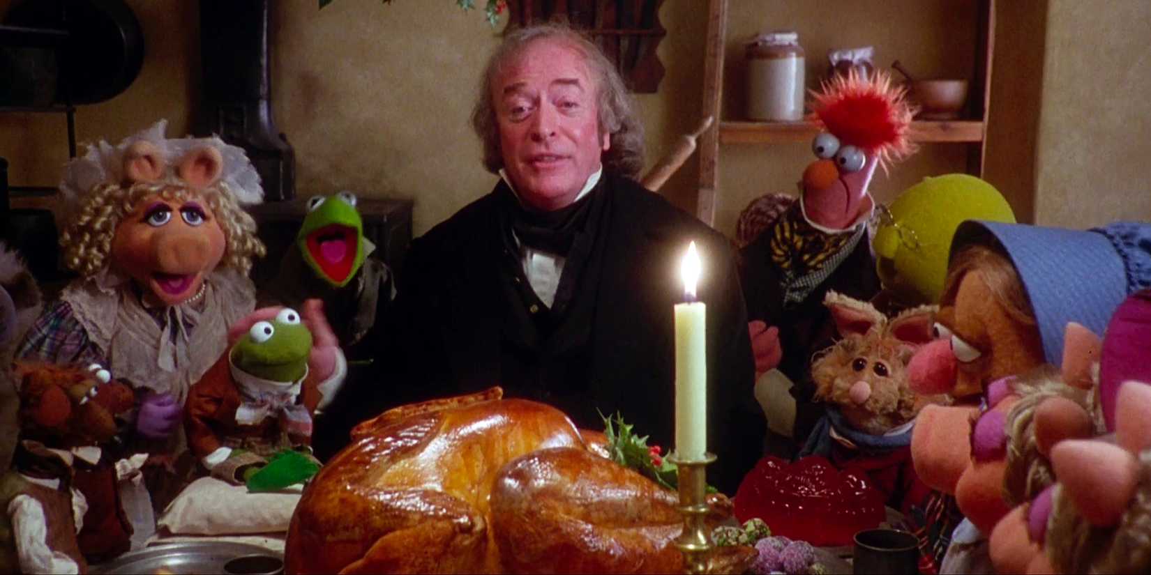 Michael Caine as Scrooge and the Muppets gather around a Christmas dinner in The Muppet Christmas Carol.