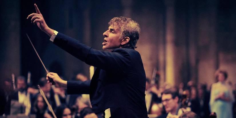Bradley Cooper as Leonard Bernstein conducting an orchestra in 'Maestro'