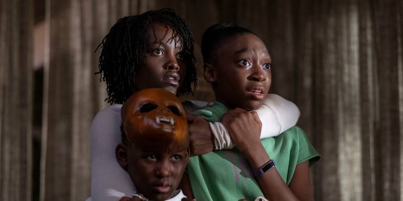 Lupita Nyong'o holding Evan Alex and Shahadi Wright Joseph in Us.