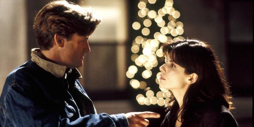 Bill Pullman and Sandra Bullock talking outdoors at night in While You Were Sleeping.