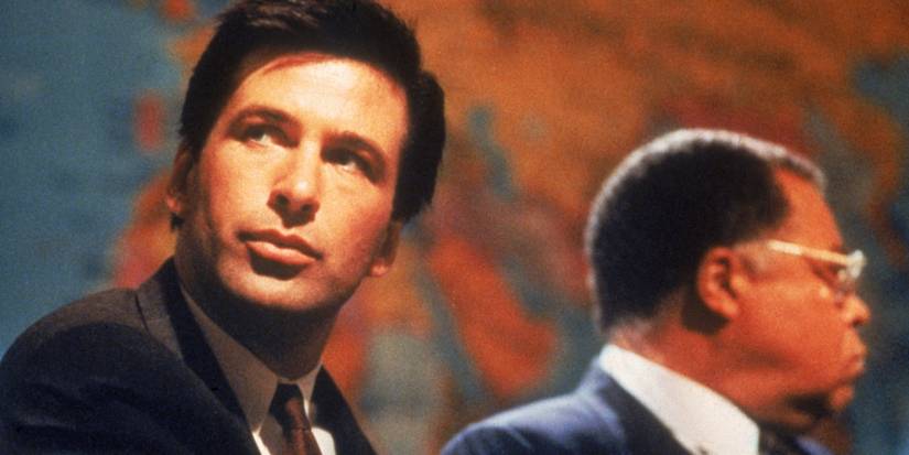 Jack Ryan looks intently beyond the camera next to Admiral James Greer in The Hunt for Red October