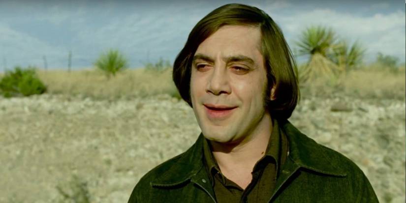  Anton Chigurh (Javier Bardem) smiling in a desert in 'No Country for Old Men'