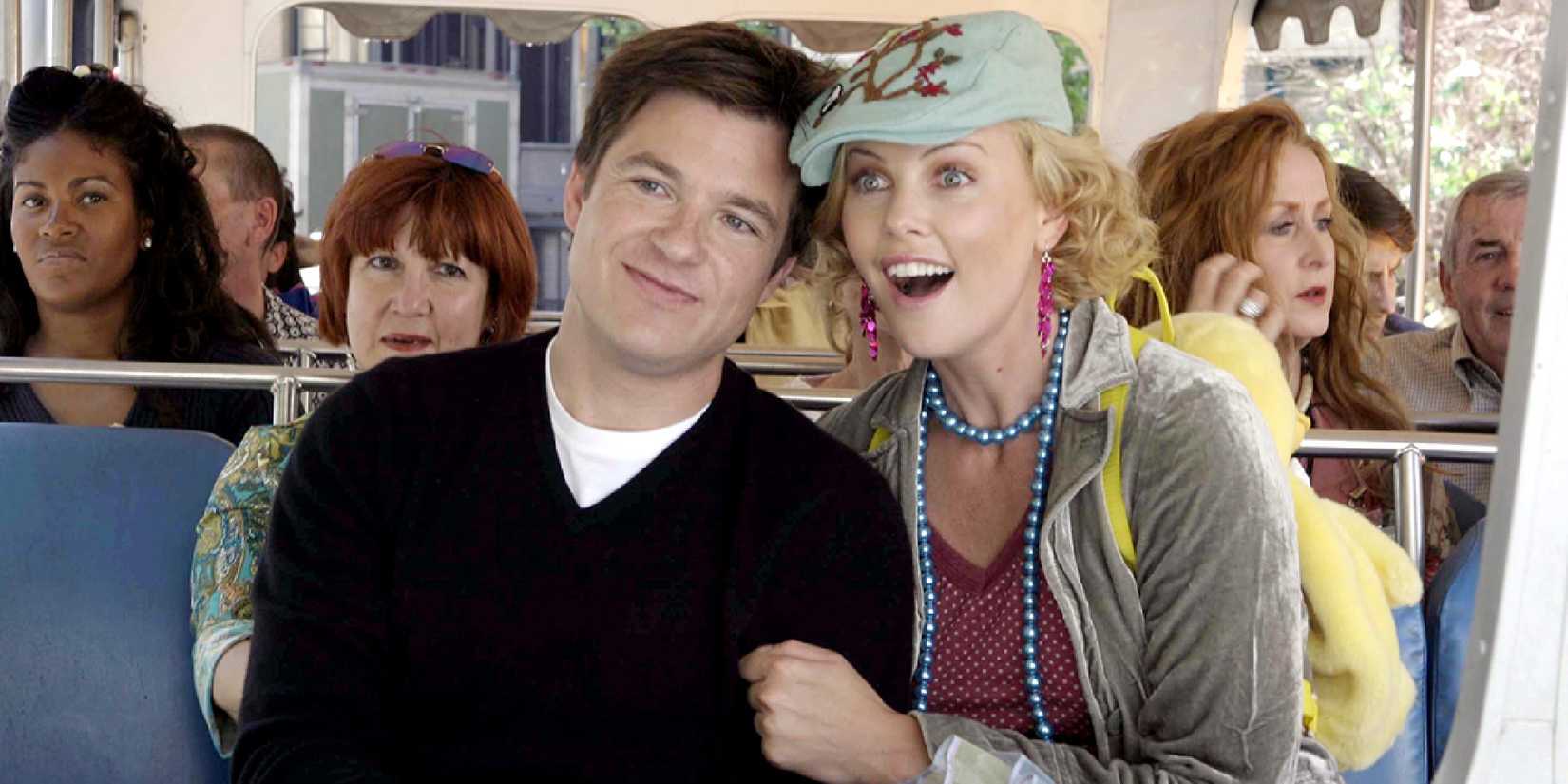 Jason Bateman and Charlize Theron sit together in a vehicle looking happy in Arrested Development Season 3
