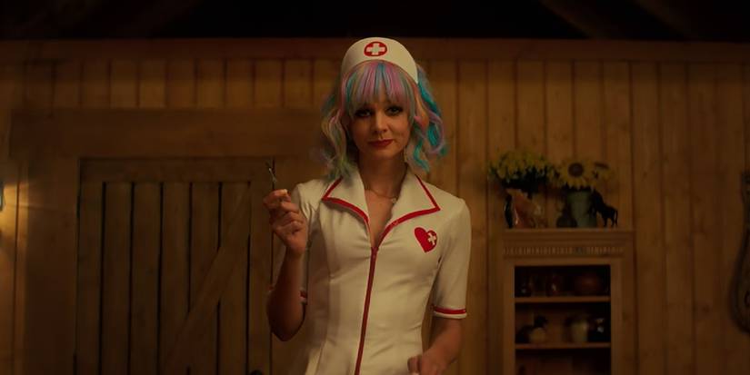 Cassie in Promising Young Woman holding a needle and wearing a nurse's uniform