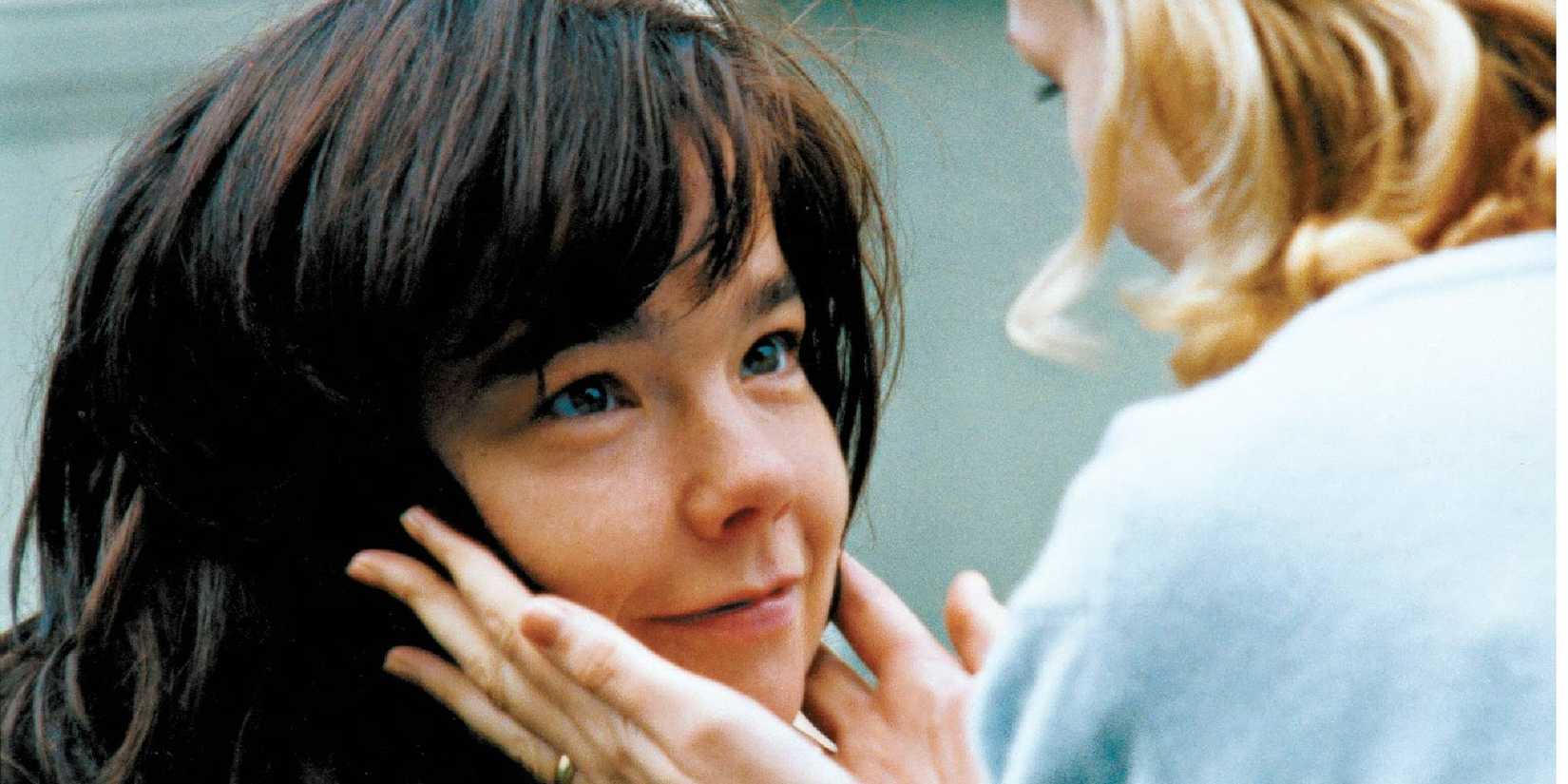 Catherine Deneuve holding Bjork's face while she smiles in Dancer in the Dark