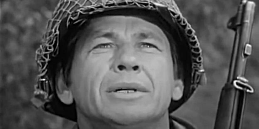 Close-up of Charles Bronson as Corporal Velasquez, holding a gun and looking into the distance on Combat!