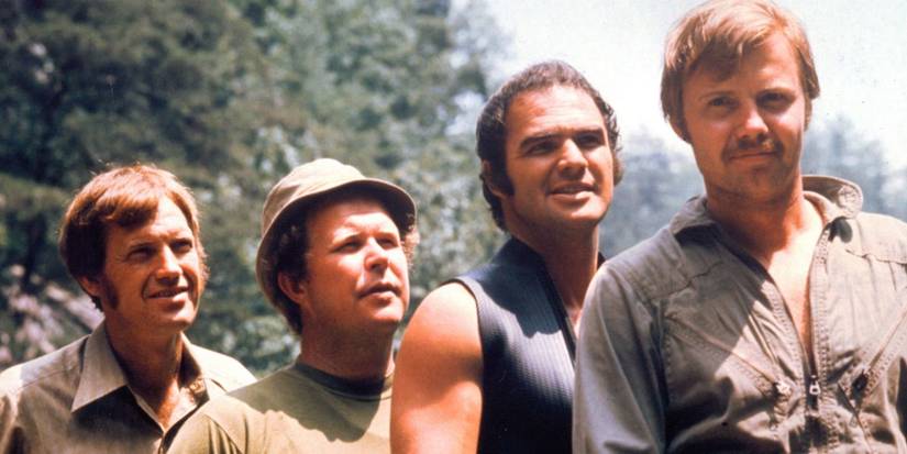 Ronny Cox, Ned Beatty, Burt Reynolds, and Jon Voight standing in a line outdoors in Deliverance.