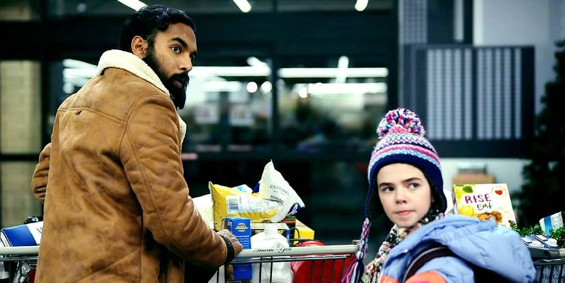 Himesh Patel as Jeevan and Matilda Lawler as Kirsten push carts full of groceries in Station Eleven.