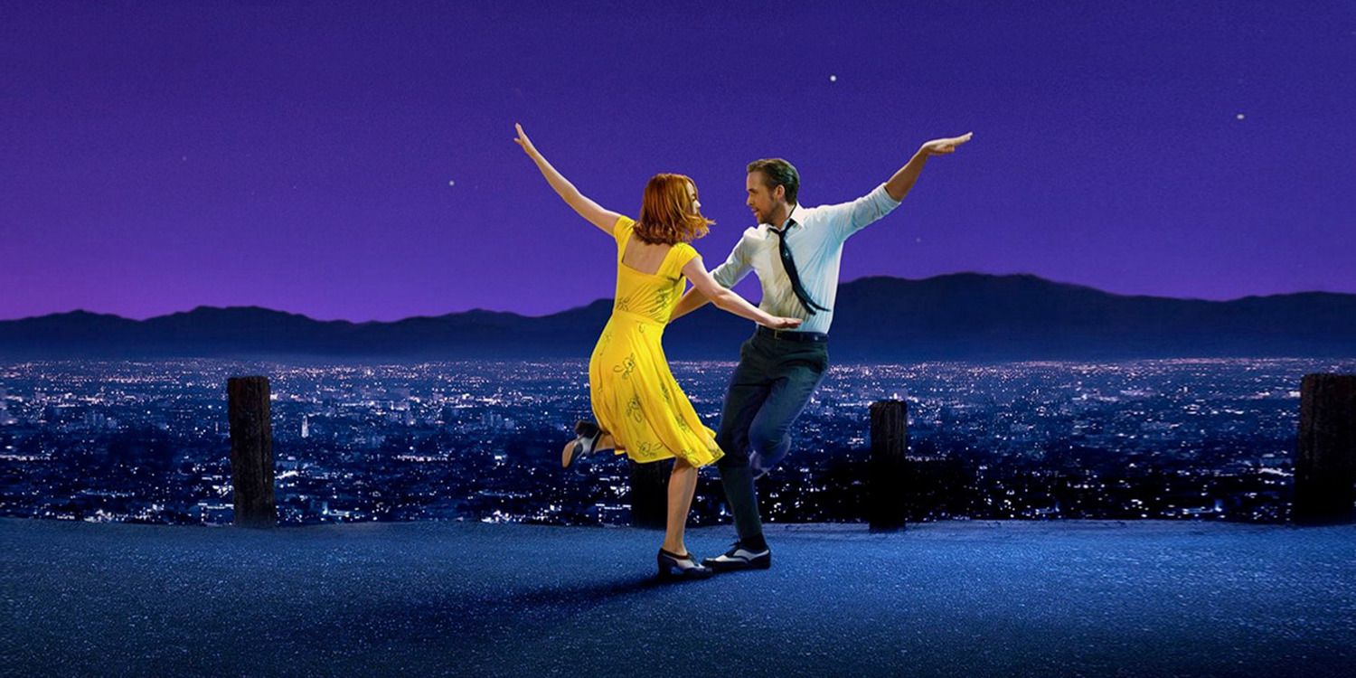 Mia and Sebastian dancing in front of a purple sky and city background in La La Land