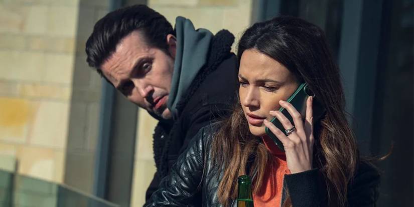 Michelle Keegan as Maya on the phone while standing next to Emmett J. Scanlan as Shane in 'Fool Me Once'