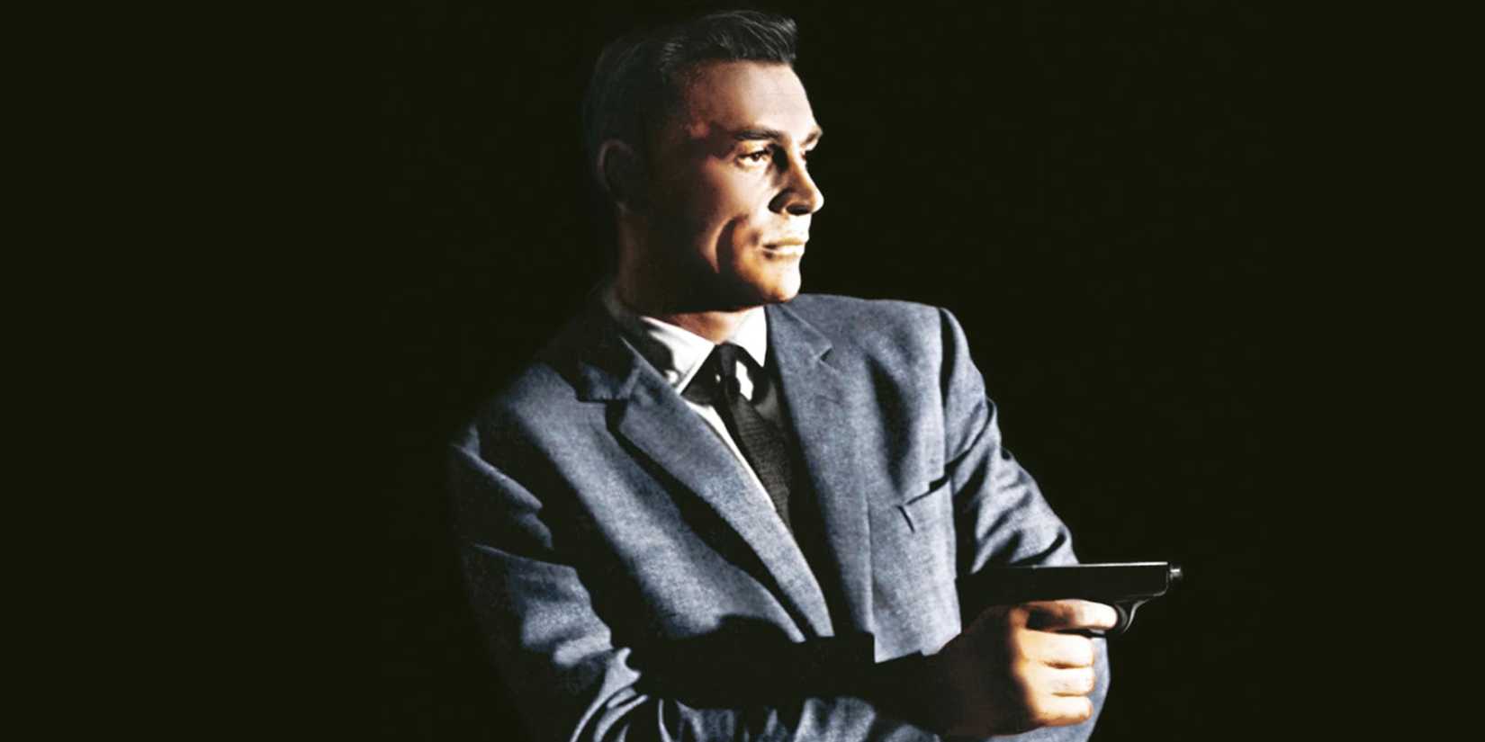 Sean Connery as James Bond / 007 holding a gun out in the From Russia With Love (1963) poster