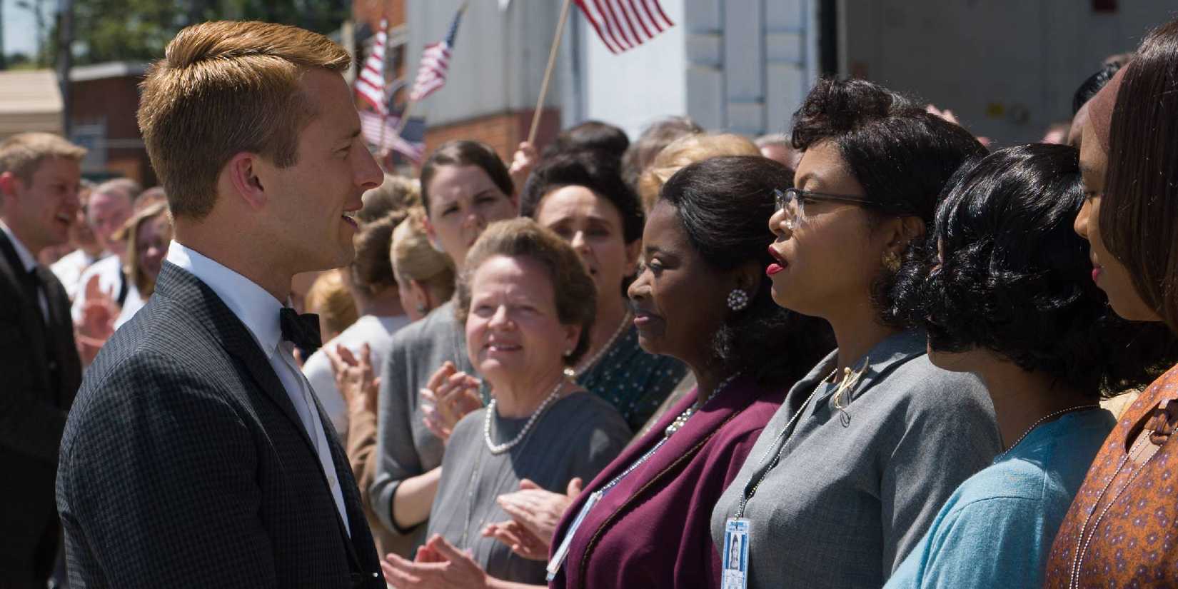 Glen Powell smiling at Taraji P. Henson in Hidden Figures.
