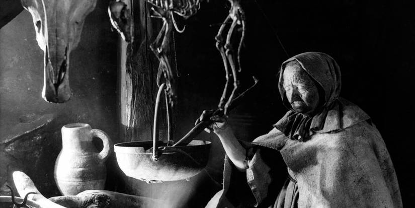 An old witch making a potion in a couldron in the film Häxan