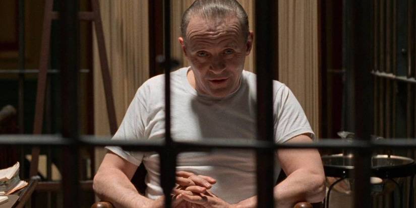 Hannibal sits in his cell with his hands folded in The Silence of the Lambs.
