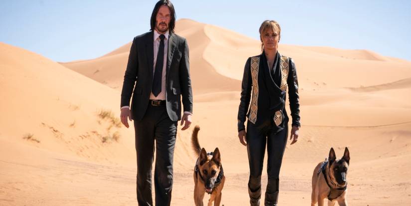 John Wick and Sofia Al-Azwar walking through the desert with two German Shepherds in John Wick 3.
