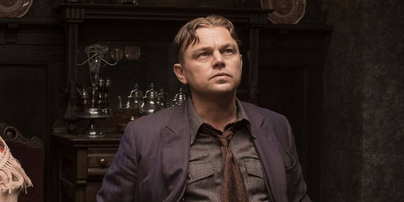 Leonardo DiCaprio as Ernest Burkhart, sitting in a dining room, in Killers of the Flower Moon