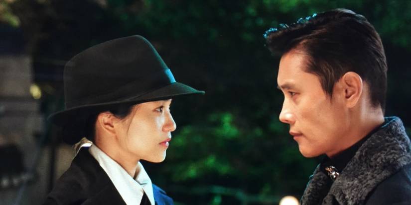 Ae-shin disguised as a man and played by Kim Tae-ri stares at Eugene played by Lee Byung-hun in Mr. Sunshine.