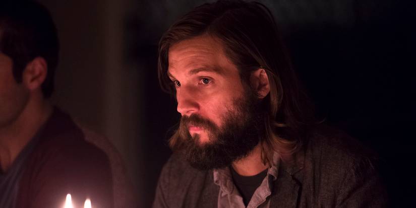 Logan Marshall Green sitting at dinner in The Invitation 2015 .