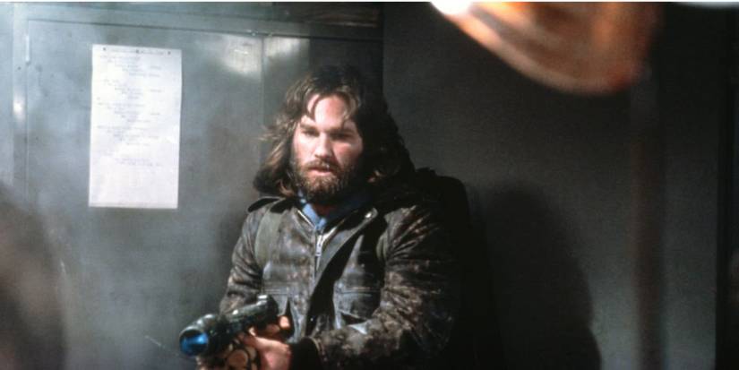 Kurt Russell as R.J. MacReady pointing a gun in 'The Thing'.