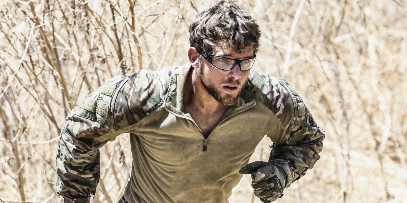 Max Thieriot as Clay Spenser, running through branches and wearing protective glasses in SEAL Team