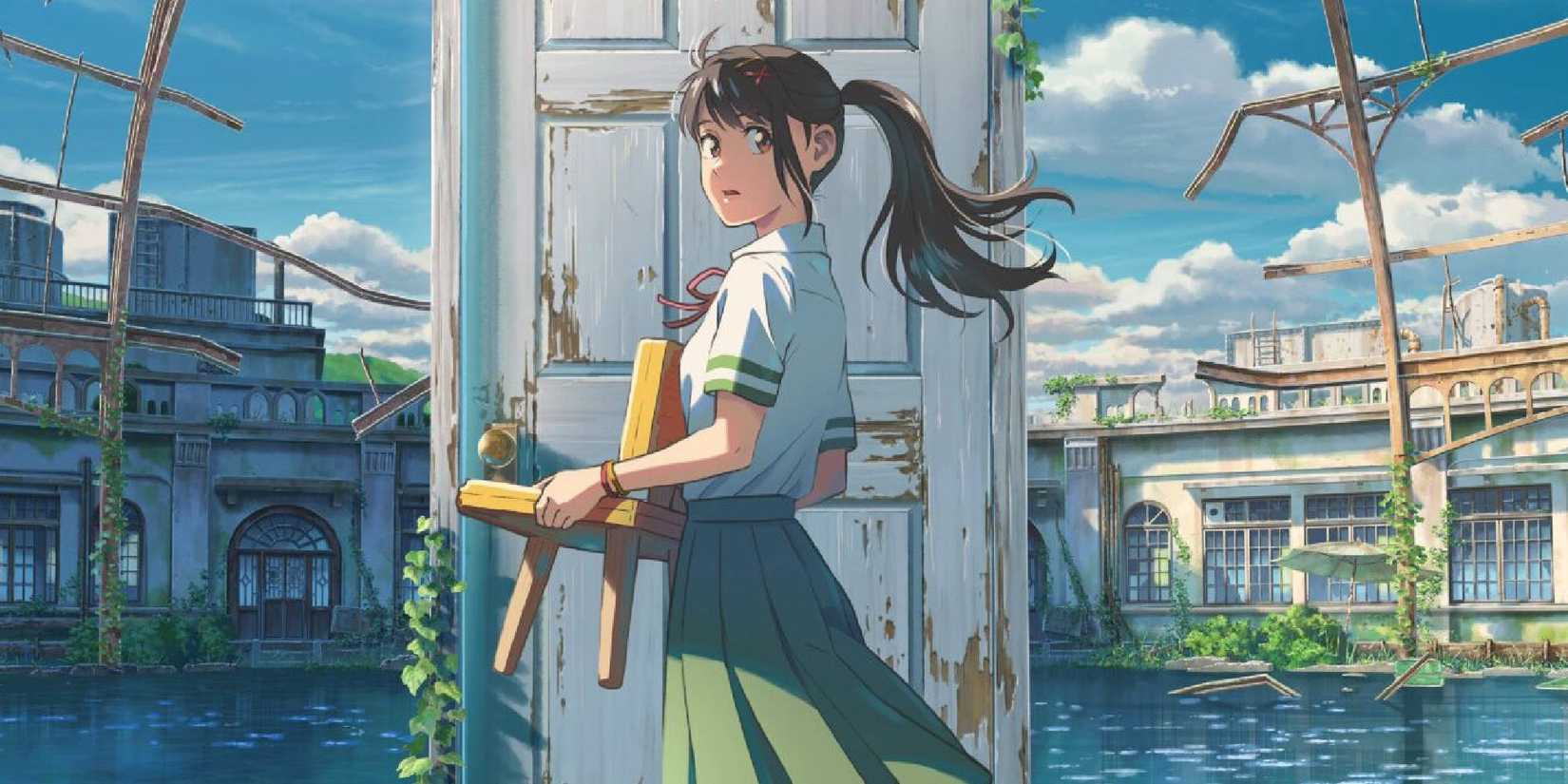 Suzume holding a very small chair while looking at the camera in Suzume