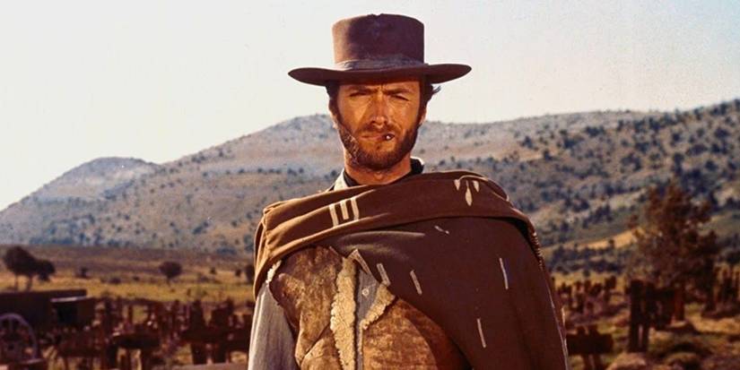 Clint Eastwood smokes a cigarette standing in a dry, arid landscape in The Good, the Bad, and the Ugly.