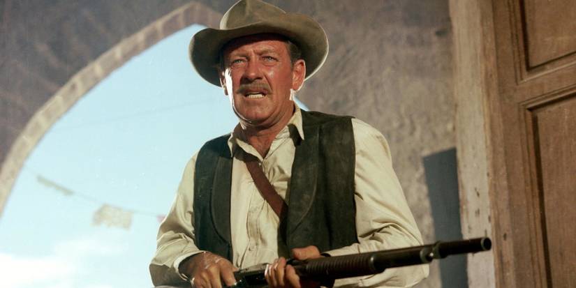 Pike Bishop holding a rifle and looking ahead in The Wild Bunch